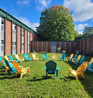 Green and yellow lawn chairs placed in a circle in the school courtyard