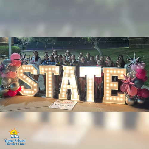 Ron Watson Cheer team in front of STATE competition sign