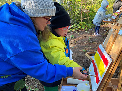 lady and student painting outside