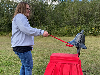 lady ringing a large bell