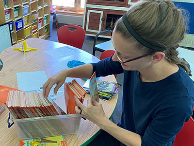 lady organizing books in a container